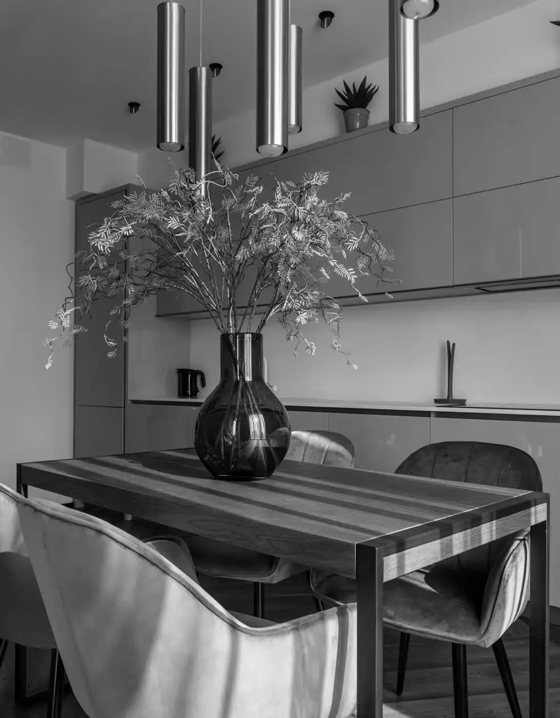 Vase with a plant in a kitchen interior in a New York single unit apartment